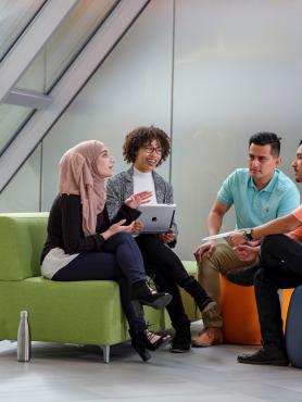 Group of four people chatting in a circle