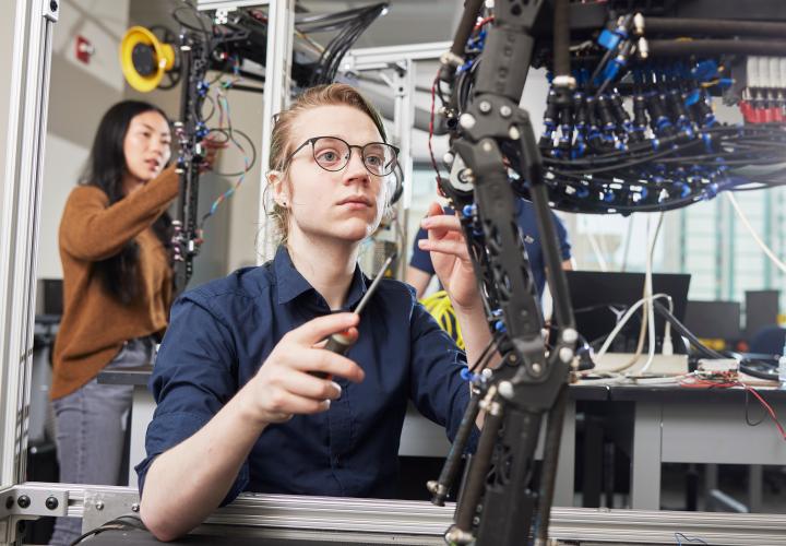 Engineering student working on a robotic dog