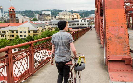 Person Walking Bicycle on Broadway Bridge