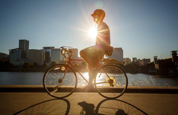 Person Biking on Waterfront (Portland Cityscape in Background)