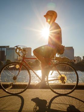 Person Biking on Waterfront (Portland Cityscape in Background)