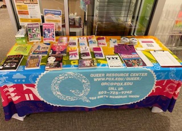 Rainbow tabled with brochures and pamphlets outside the QRC