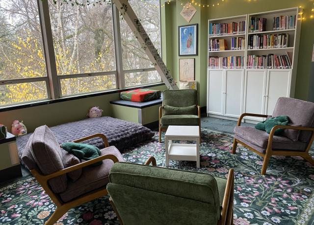 Library with queer art and comfortable lounge chairs