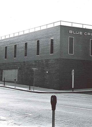 A black and white photo of the corner of the Blue Cross of Oregon building. 