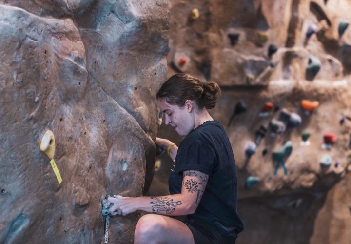 Person climbing on rock wall.