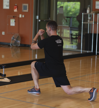 Personal trainer performing a lunge