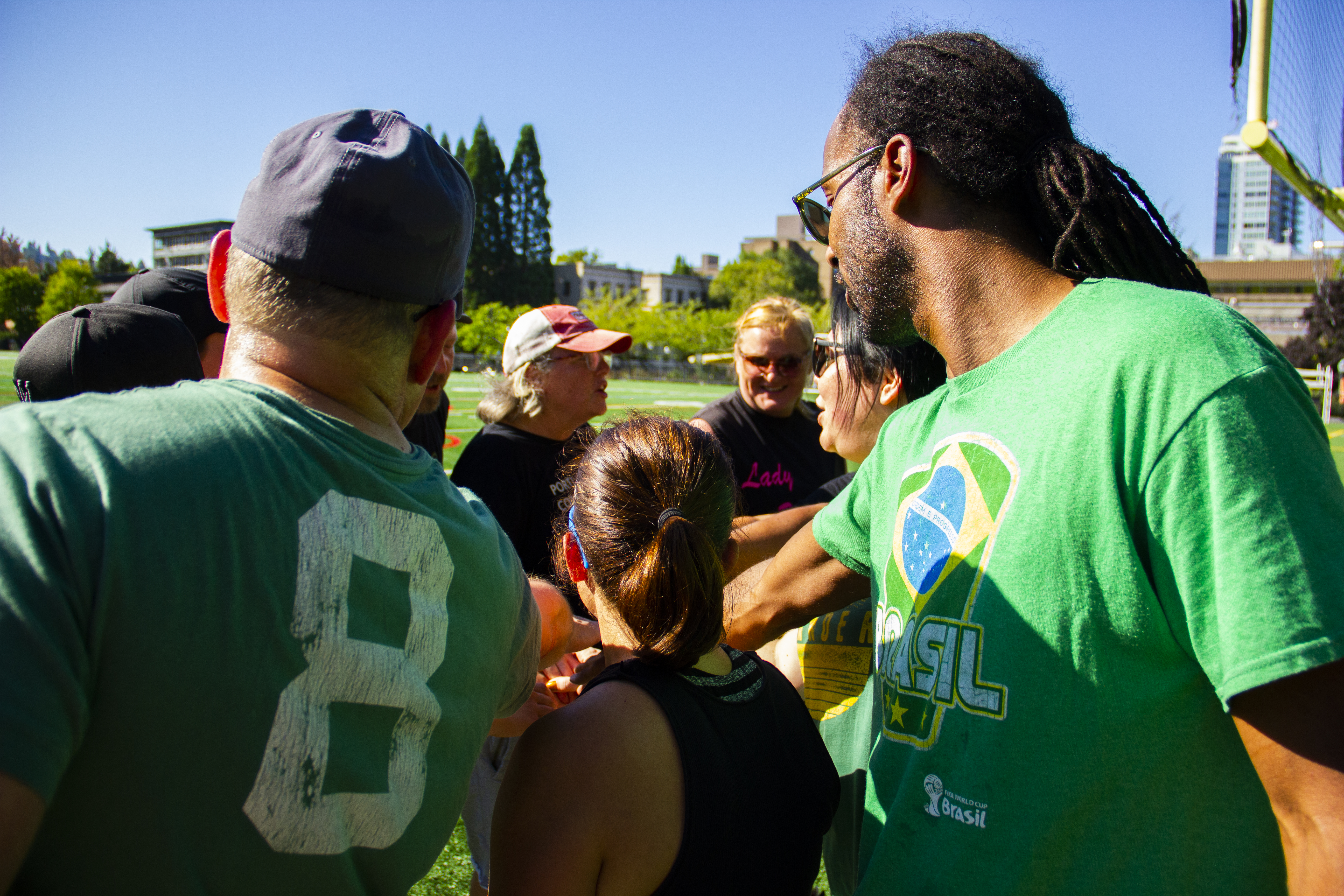 A group of people together in a group huddle. 