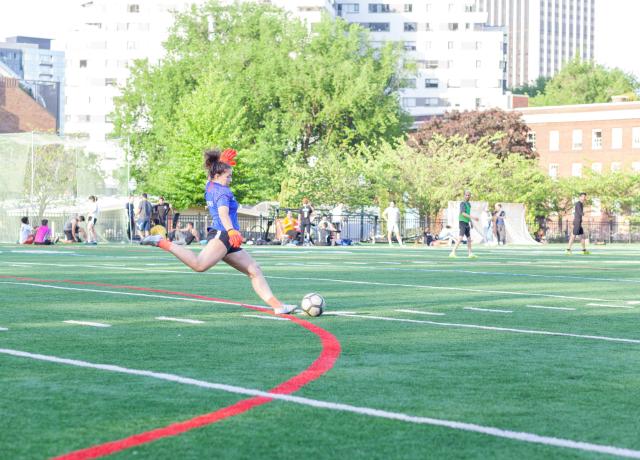 Person kicking soccer ball