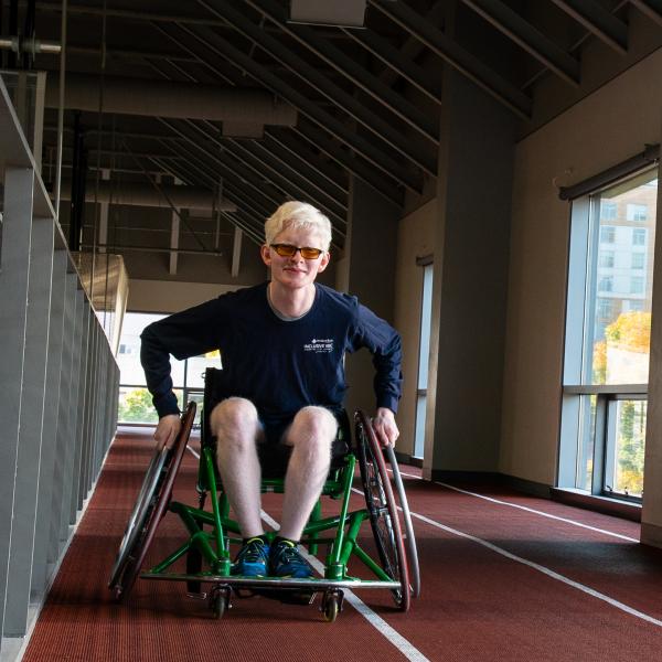 person in wheelchair on track