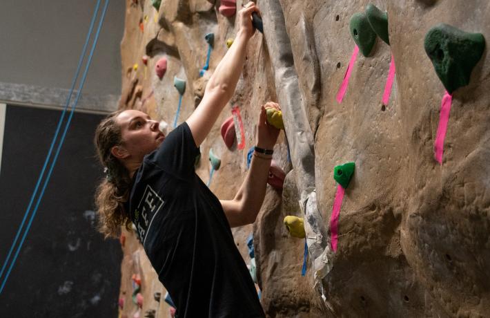 Person climbing the rock wall