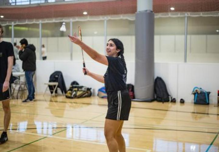 Women serving badminton birdy