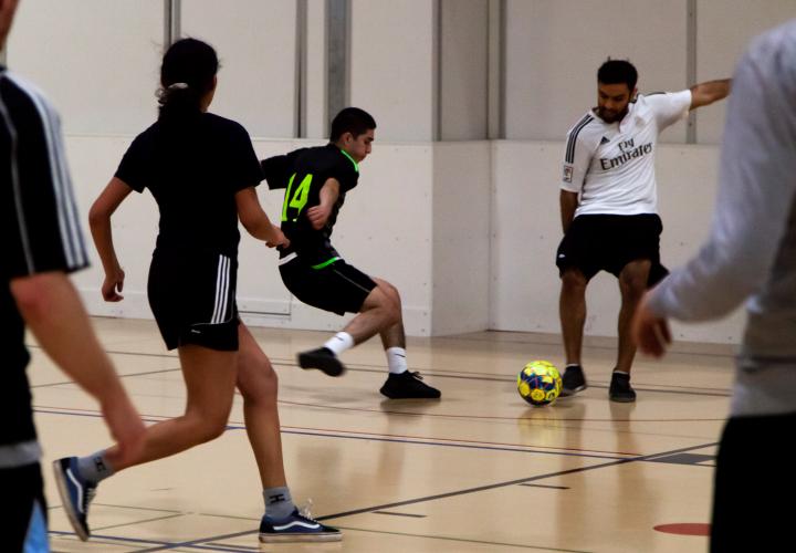 Group of people playing indoor soccer