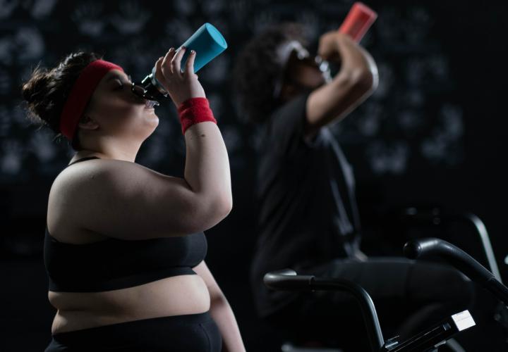 Two people on cardio bikes