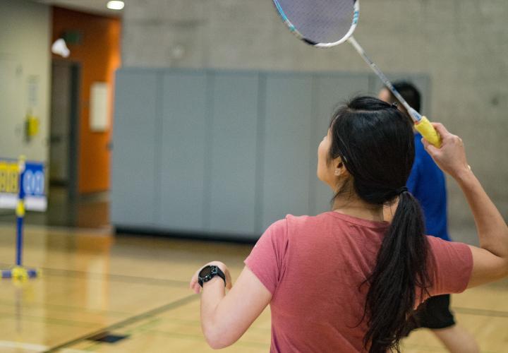 Person swinging badminton racket