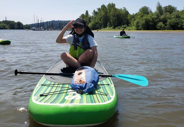 Person sitting on inflatable raft on a river