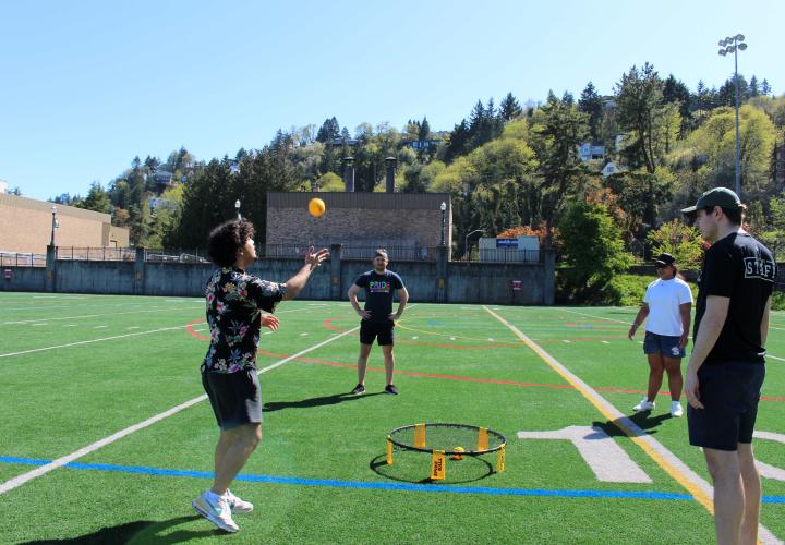4 people playing spike ball