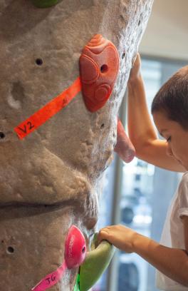 A youth member climbs on the Climbing Wall
