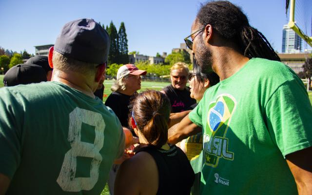 people putting hands in for team cheer