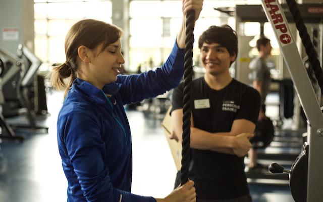 Personal trainer helping a client