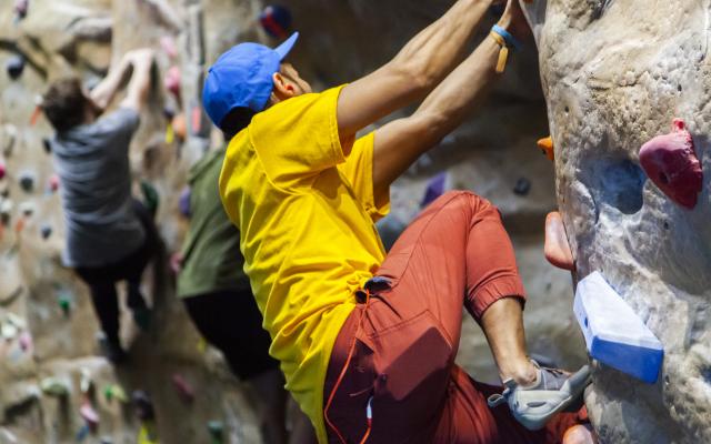 person climbing on rock wall