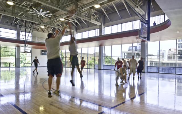 People playing basketball on the courts