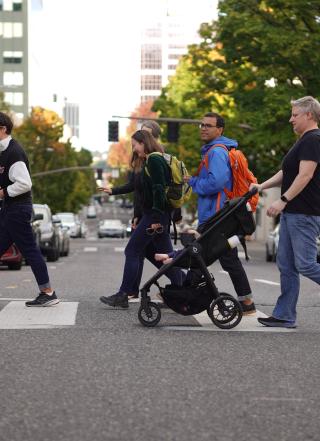 Group of people walking across a crosswalk