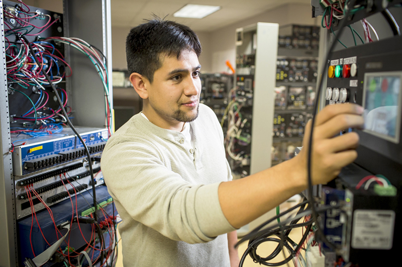 Student researcher working on servers