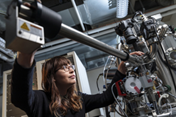 Student researcher working on a microscope