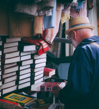 Older adult looking at books