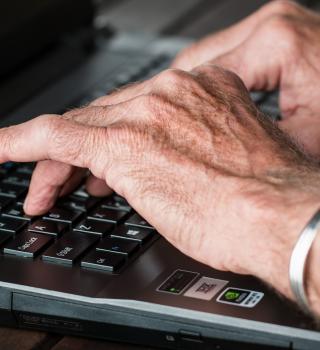 fingers typing on keyboard