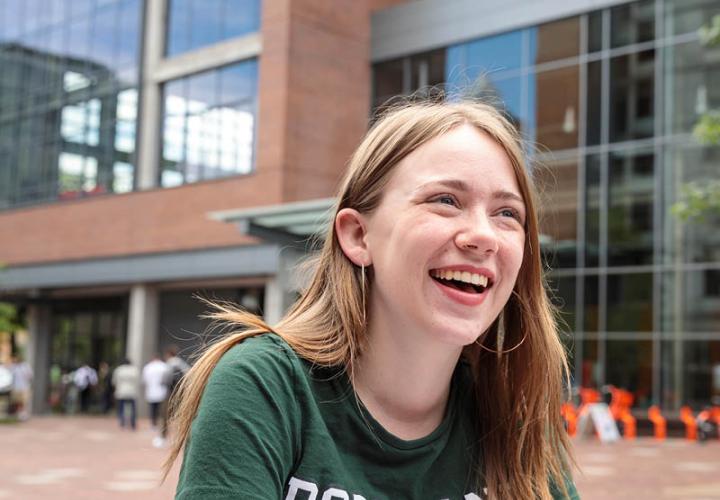 Female student sitting in Urban Plaza