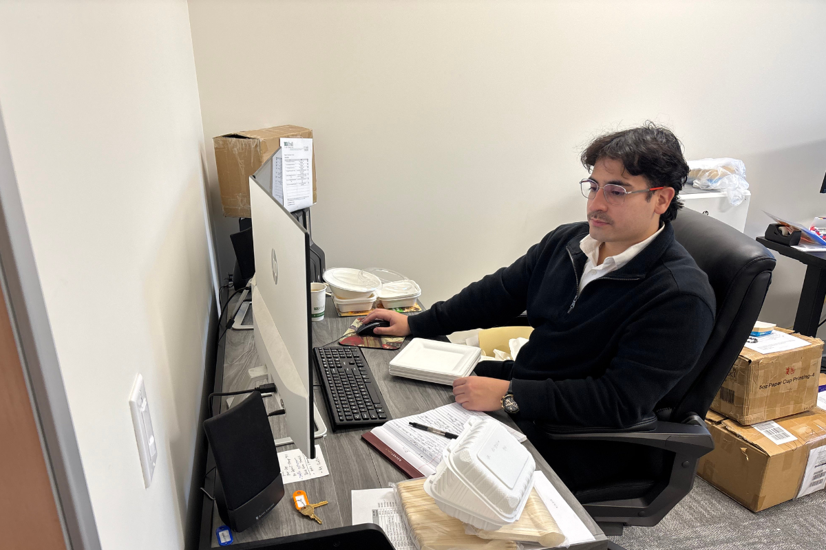 Hunter working at his desk on his computer