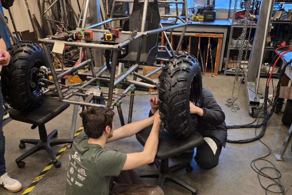 Mechanical Engineering Capstone students, Toby Greene and +1 working on the front suspension of the Viking Motorsports SAE Baja 2026 vehicle - Engineering Building EB-495 - Portland State University, Maseeh College of Engineering and Computer Science 