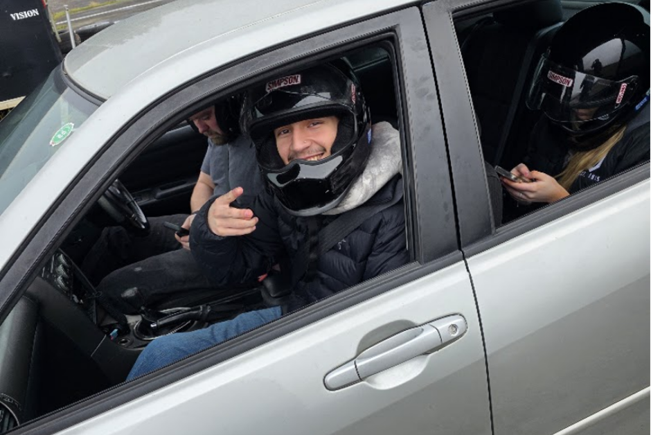 Anthony Novelo, incoming freshman, sports management major, waving during VMS Spirit Peaks Winter Break drift event - Spirit Peaks Raceway, WA 