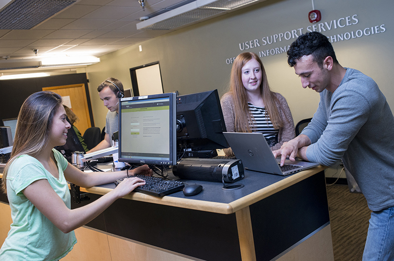 students getting help in the computer lab