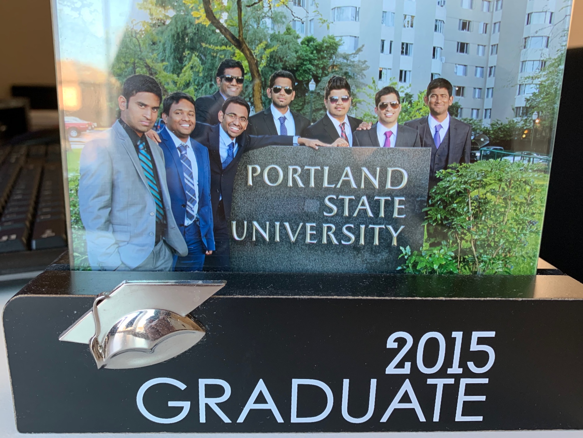 There is a photo frame with a picture of graduates.