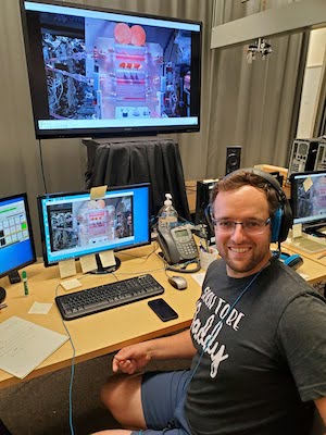 Marc Wasserman in front of a live video feed from the International Space Station