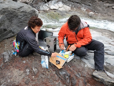 professor and student preparing samples to go in a microscope on Mount Saint Helens