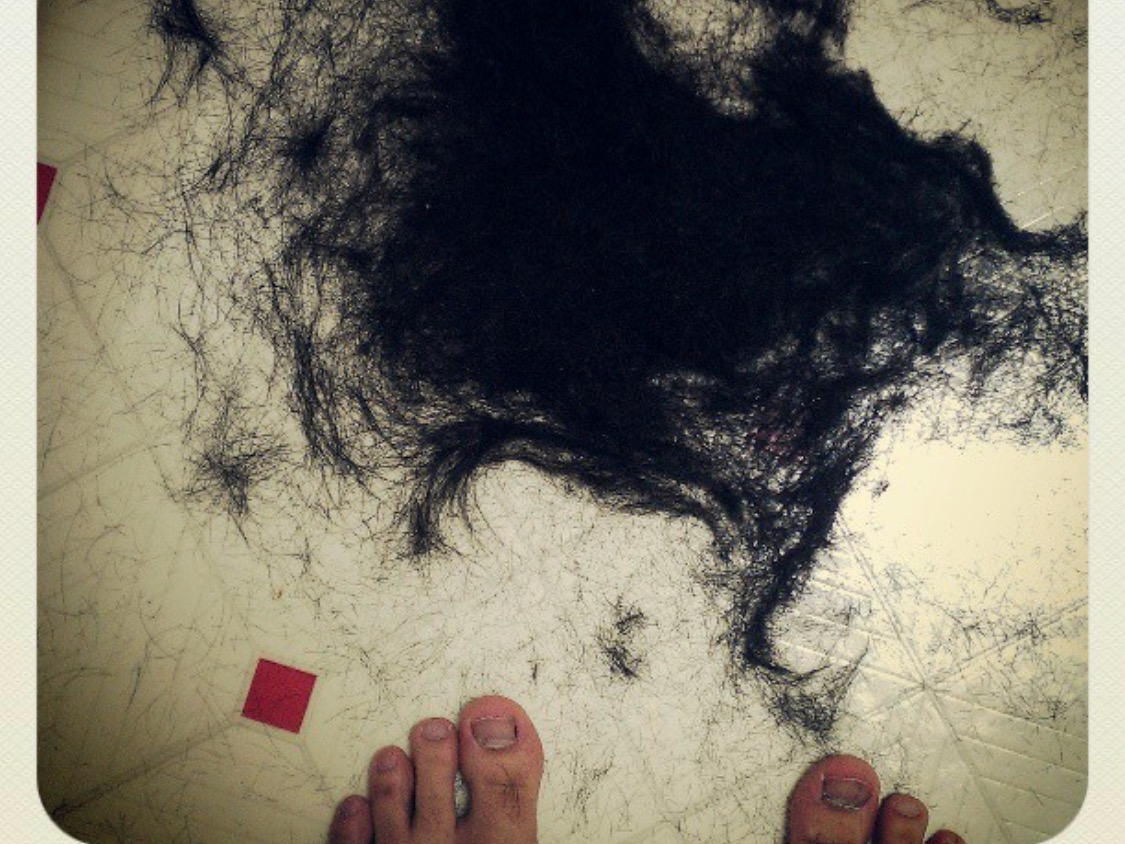 There is a pile of black hair on the floor.
