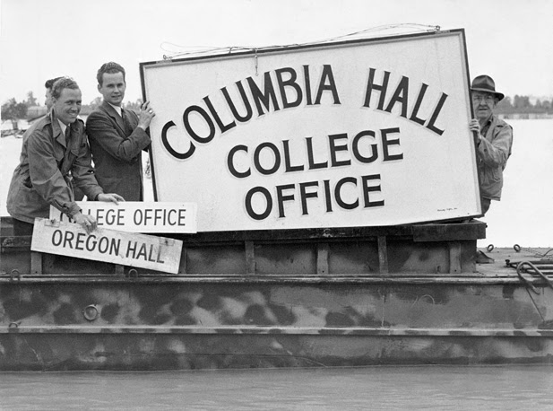 People display Extension Center signs recovered from the flood waters