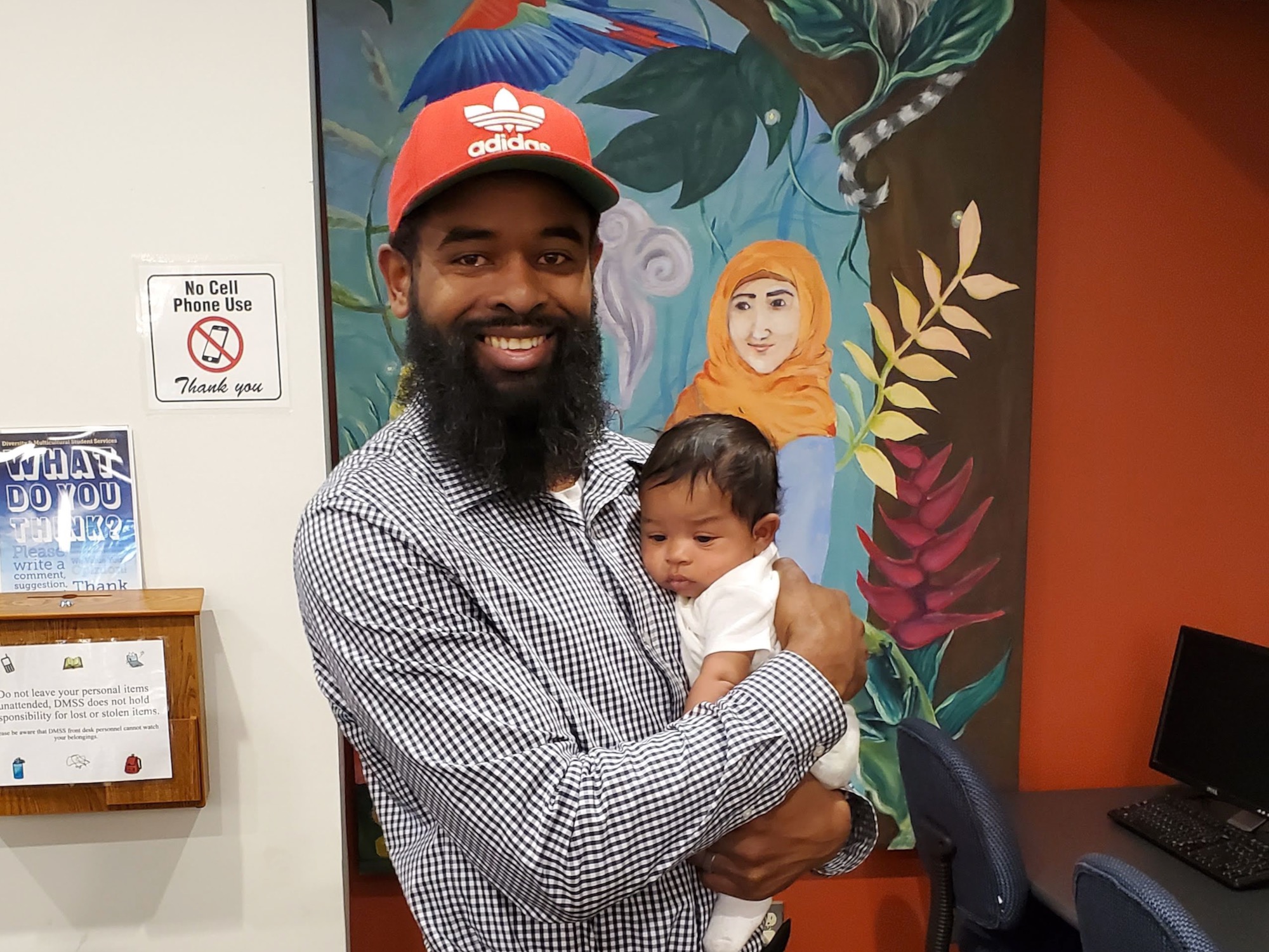 The image is of a person holding a baby.