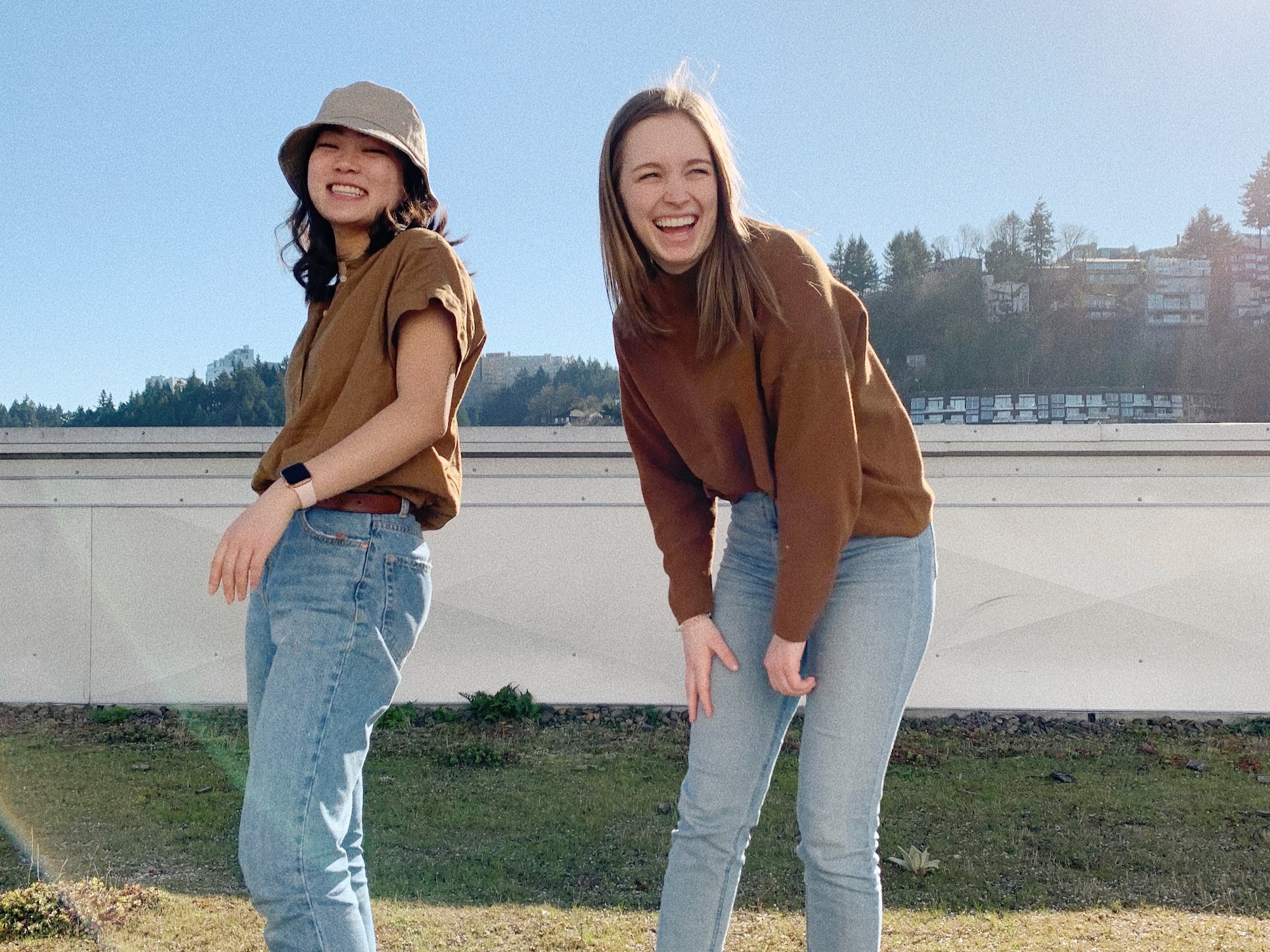 The image is of two people laughing in the sunshine. 