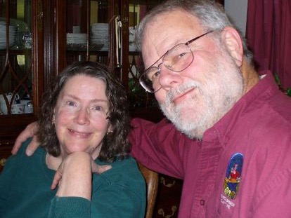 There are two people posing for the camera. 