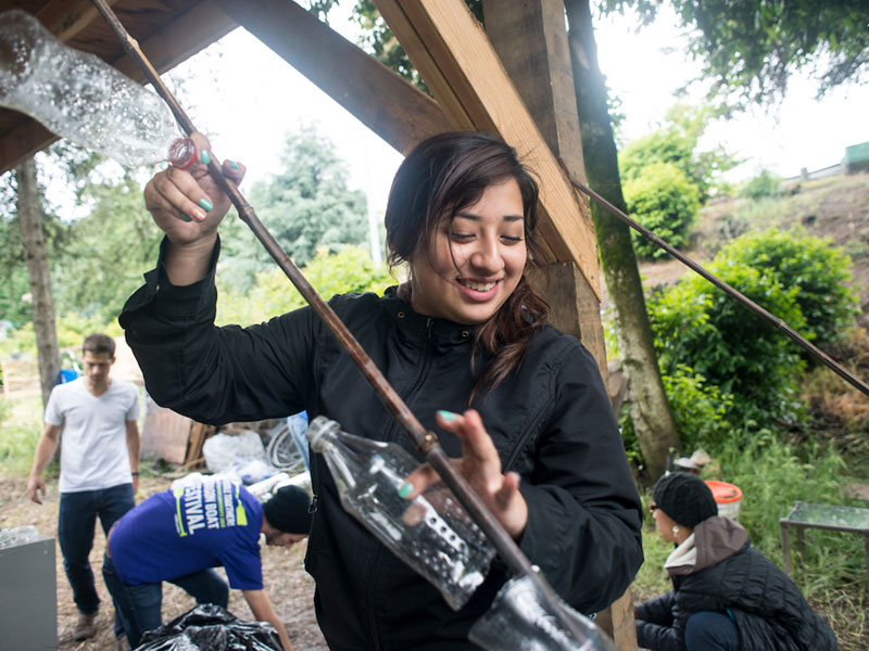 student helping to build a greenhouse