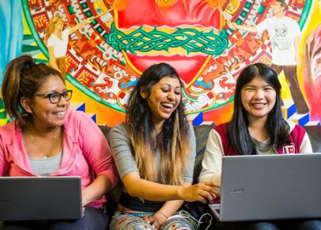 three PSU students studying together