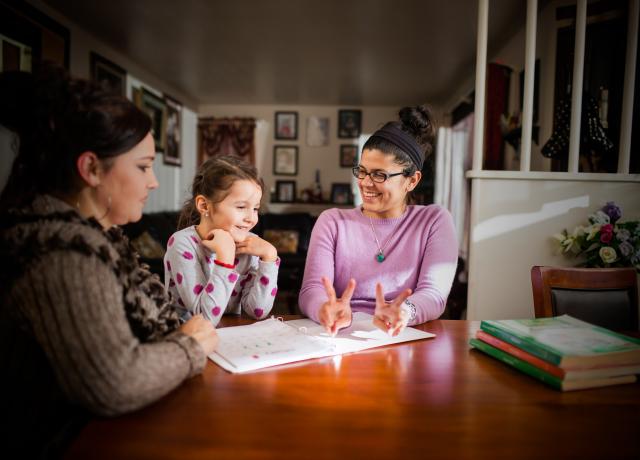 Teacher working with child and parent