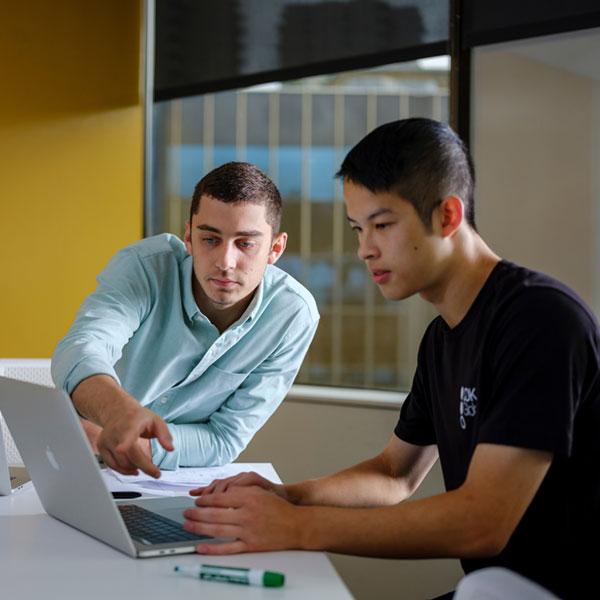  Two people working at a computer