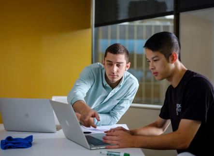  Two people working at a computer