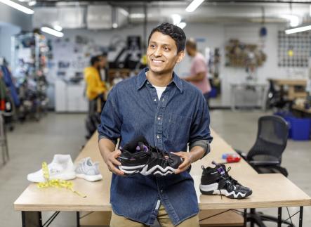 Man holding tennis shoe
