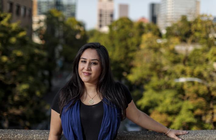 OSHU-PSU School of Public Health health administration student standing on a skybridge